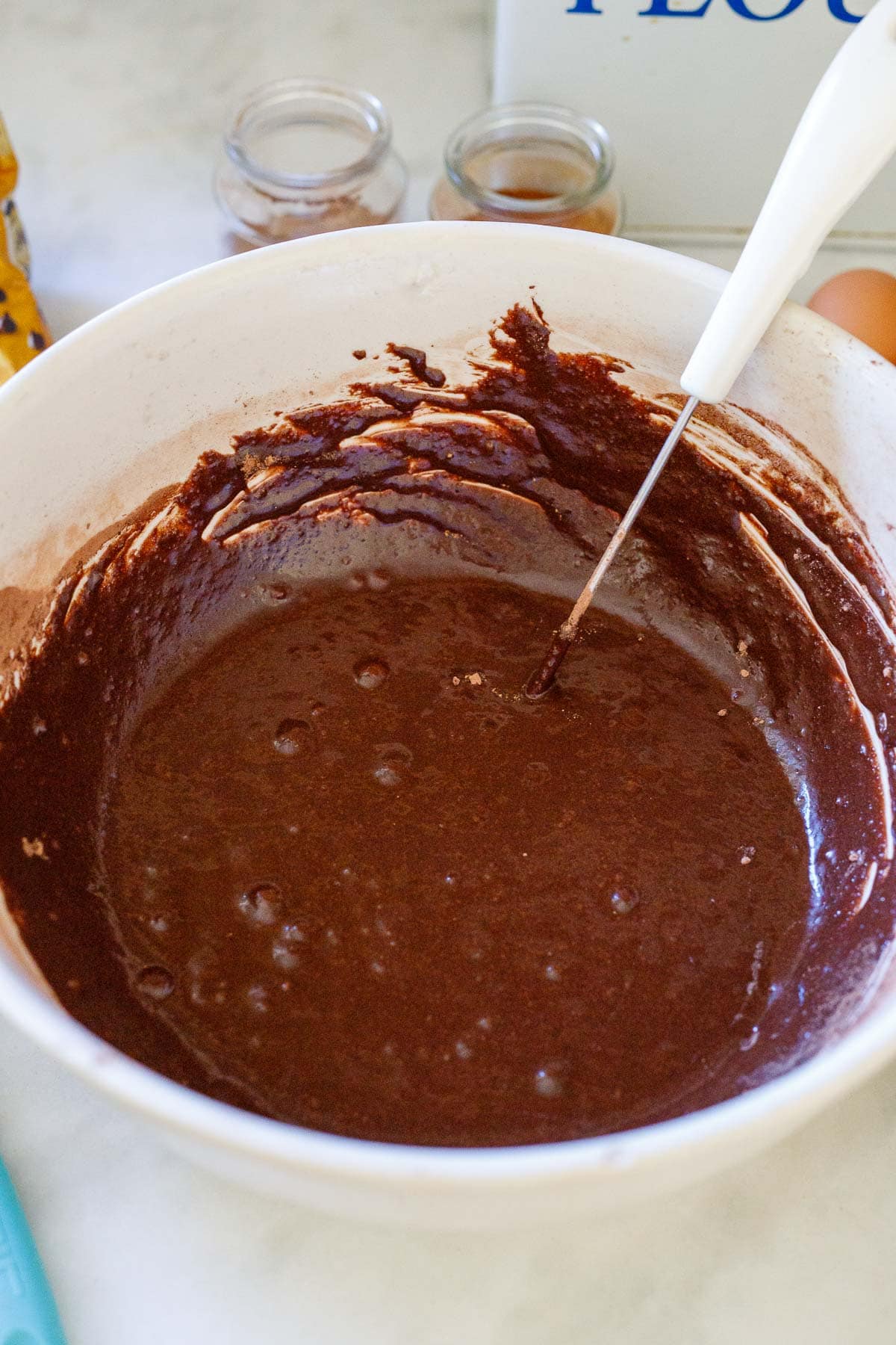 cocoa powder wet mixture in a mixing bowl with whisk