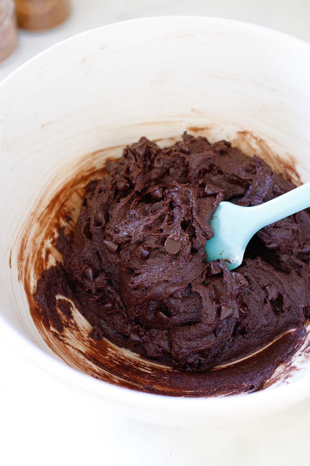 mixing bowl with double chocolate chip cookie dough and spatula