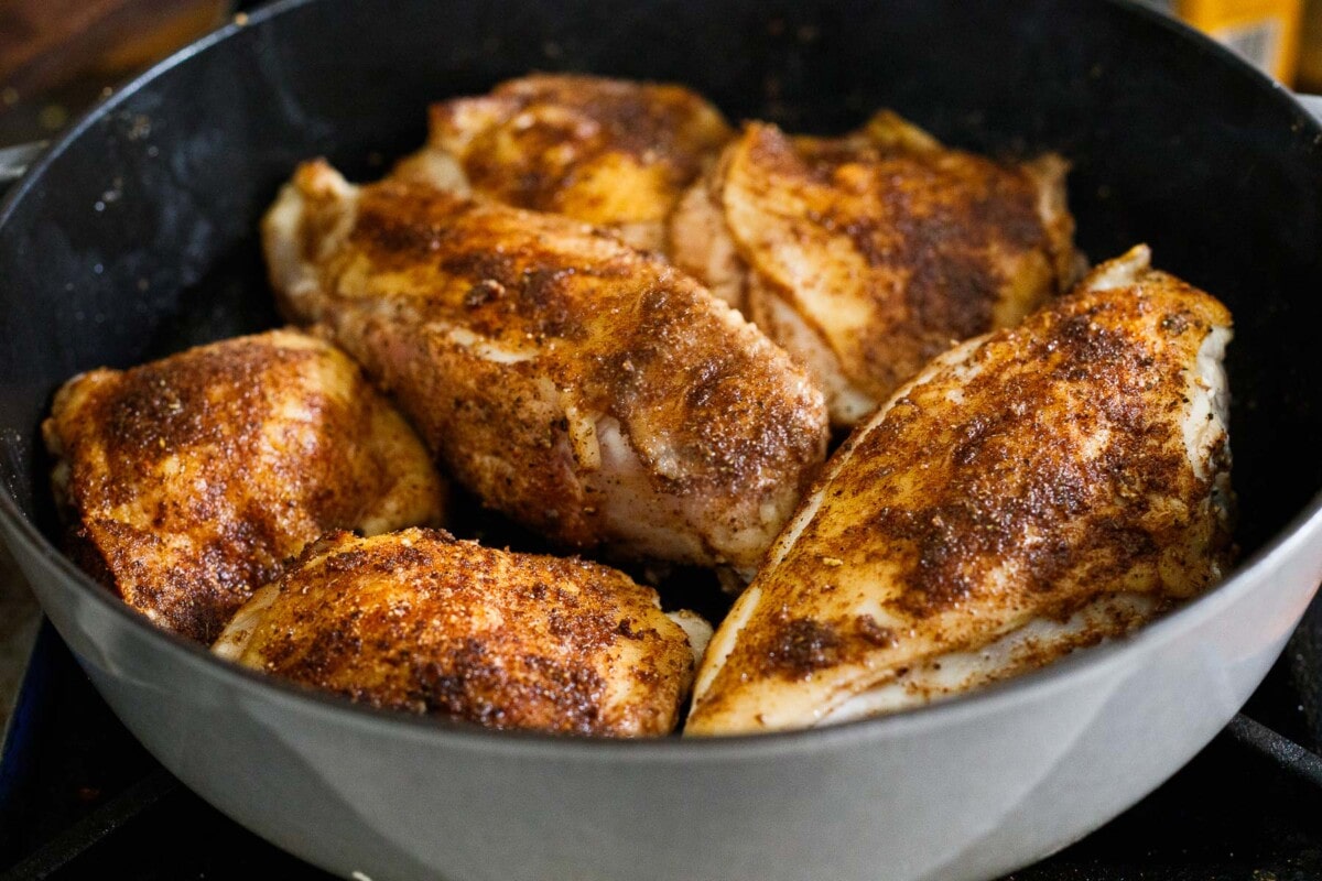 Persian chicken searing in dutch oven with Baharat spices