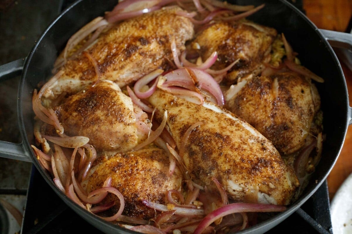 Persian chicken in dutch oven with red onions and saffron rice