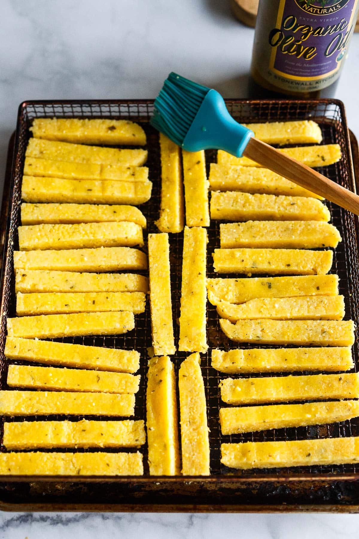 Polenta fries on air fryer tray.