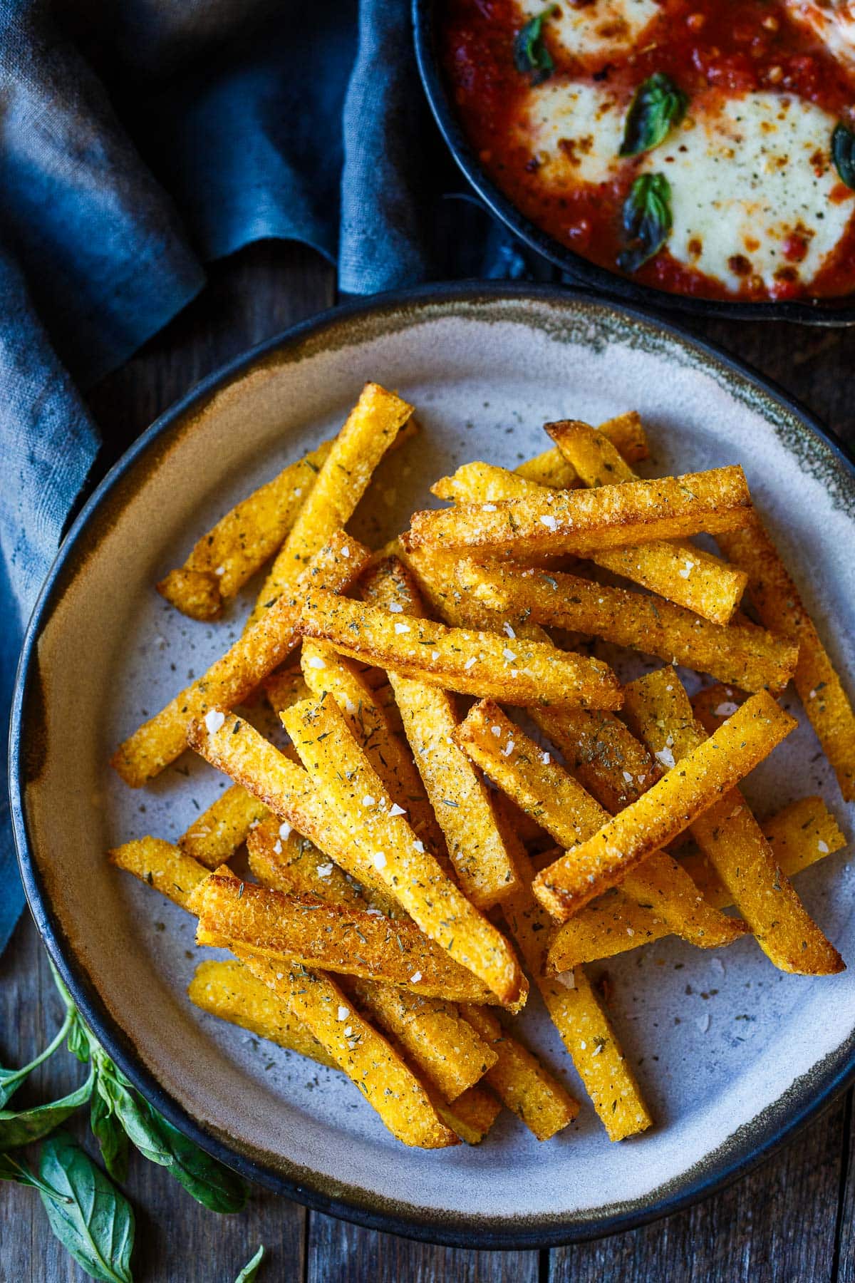 Crispy air fryer Polenta Fries! Whether you enjoy them as a snack, side dish, or appetizer, these polenta fries offer a delightful twist on a classic favorite. Give them a try and savor their crispy, tender goodness! Vegan and Gluten-free. (Directions for conventional oven included.)