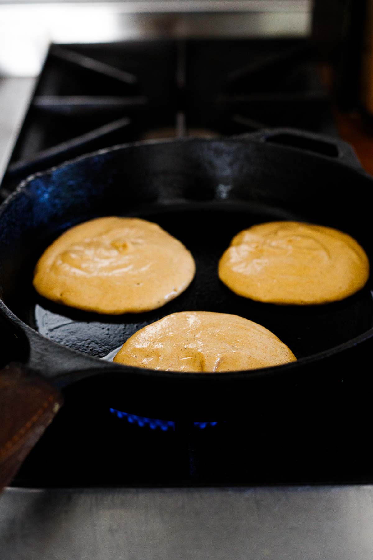 uncooked pumpkin pancakes on cast iron skillet