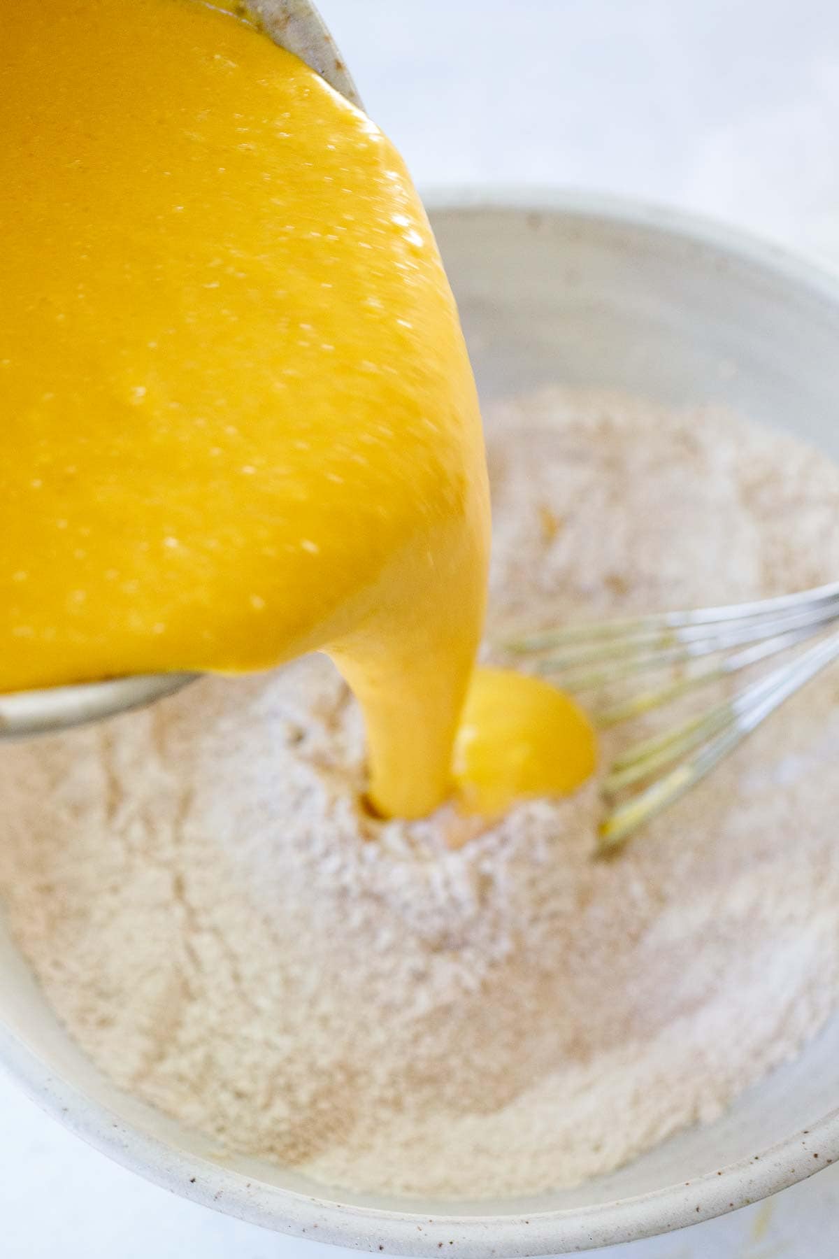 pumpkin pancake batter wet ingredients poured into bowl dry ingredients