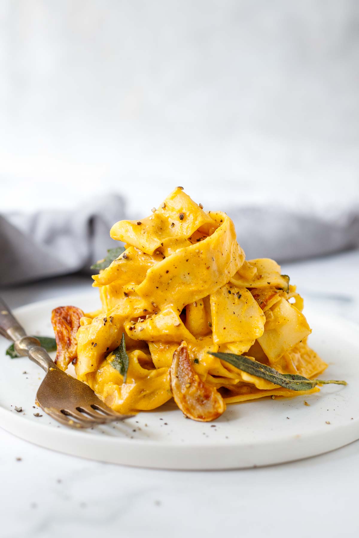 This creamy Pumpkin Pasta recipe is made with simple ingredients in under 15 minutes. Deceptively vegan, it will soon become your new favorite!