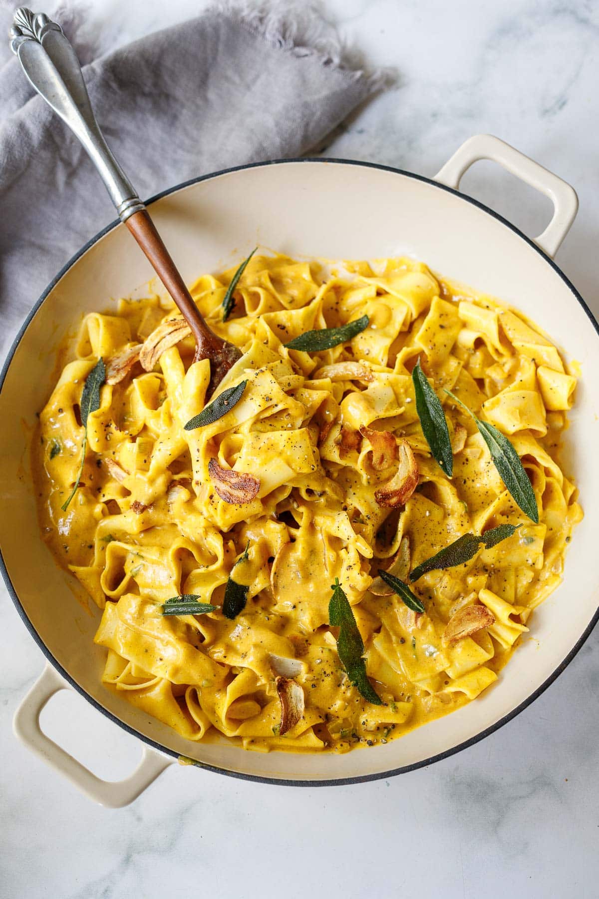 creamy pumpkin pasta with papperadelle, garnished with garlic chips and crispy sage