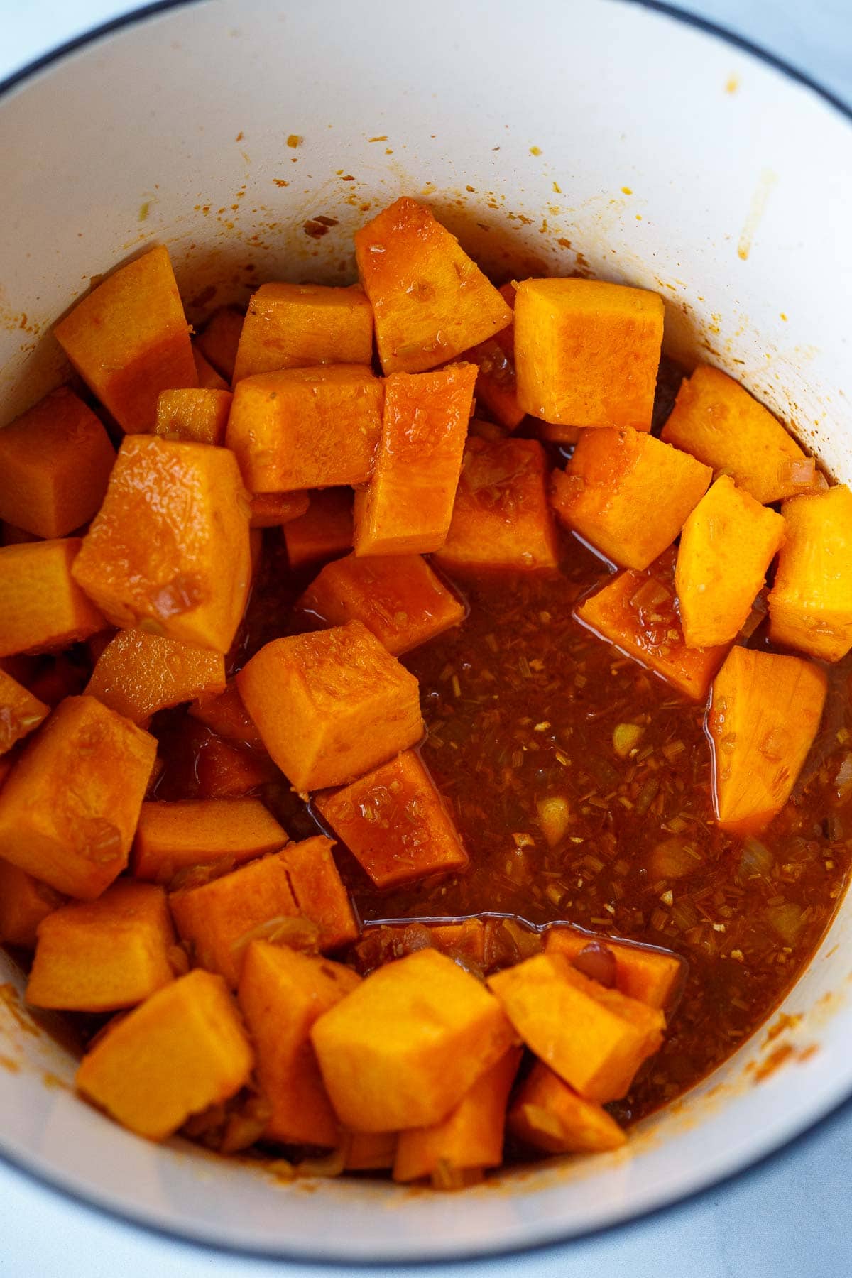 Pumpkin simmering in broth for pumpkin curry.