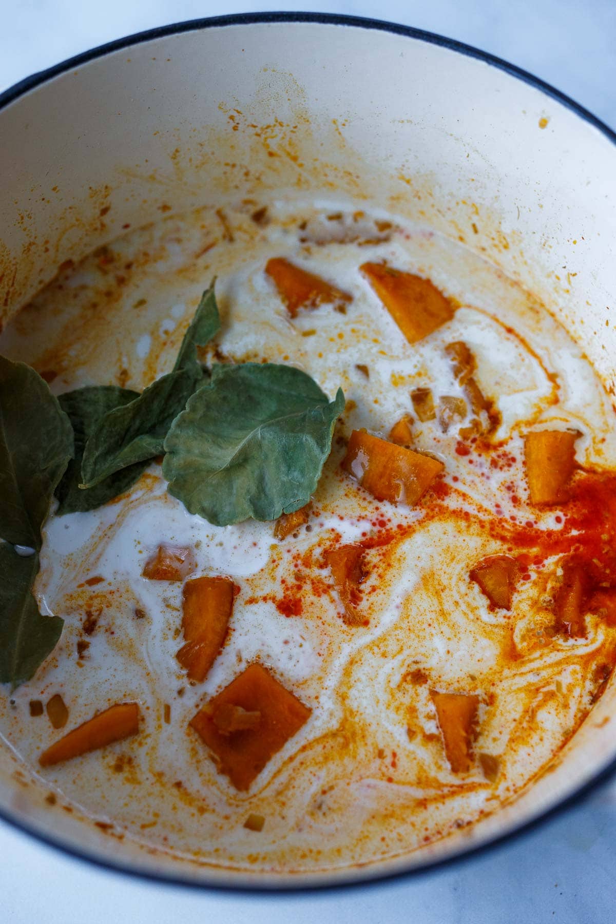 Coconut milk is added to pumpkin curry.