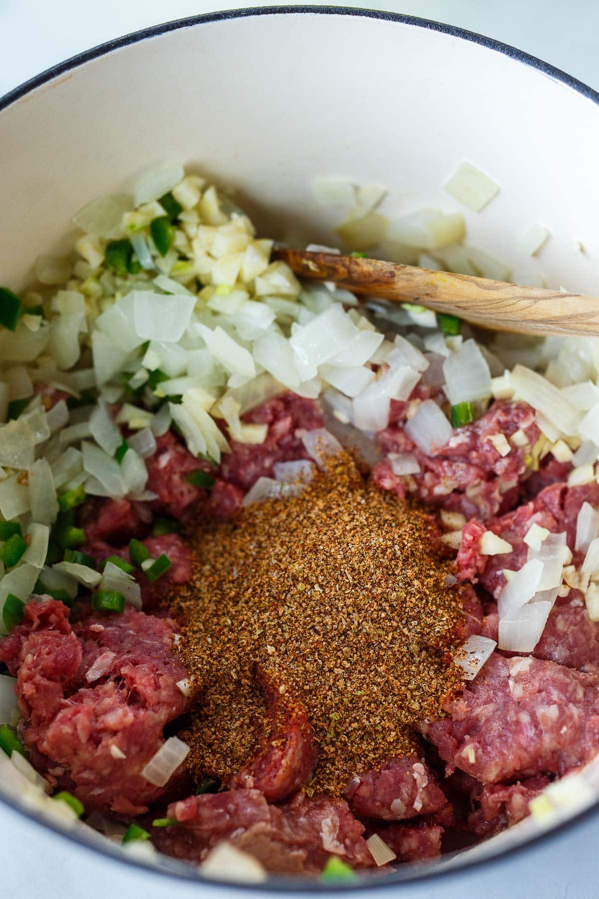Adding ground meat to the sauteed onions for Taco Soup.