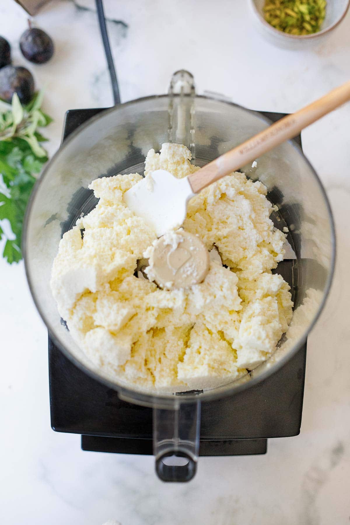 ricotta cheese in food processor with spatula