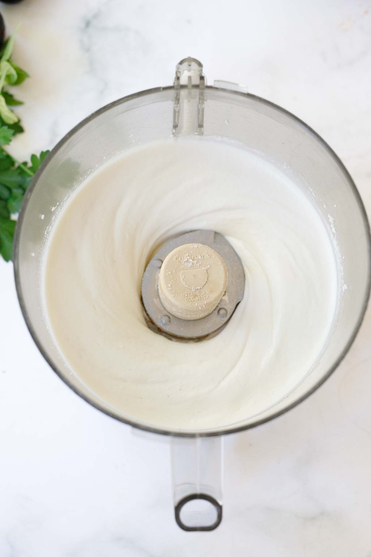 food processor blending smooth whipped ricotta