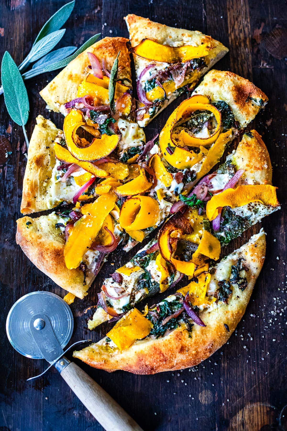 A delicious fall-inspired pizza topped with butternut squash ribbons, sage, caramelized onions, swiss chard and burrata cheese. Cozy fall flavors make the perfect bite!