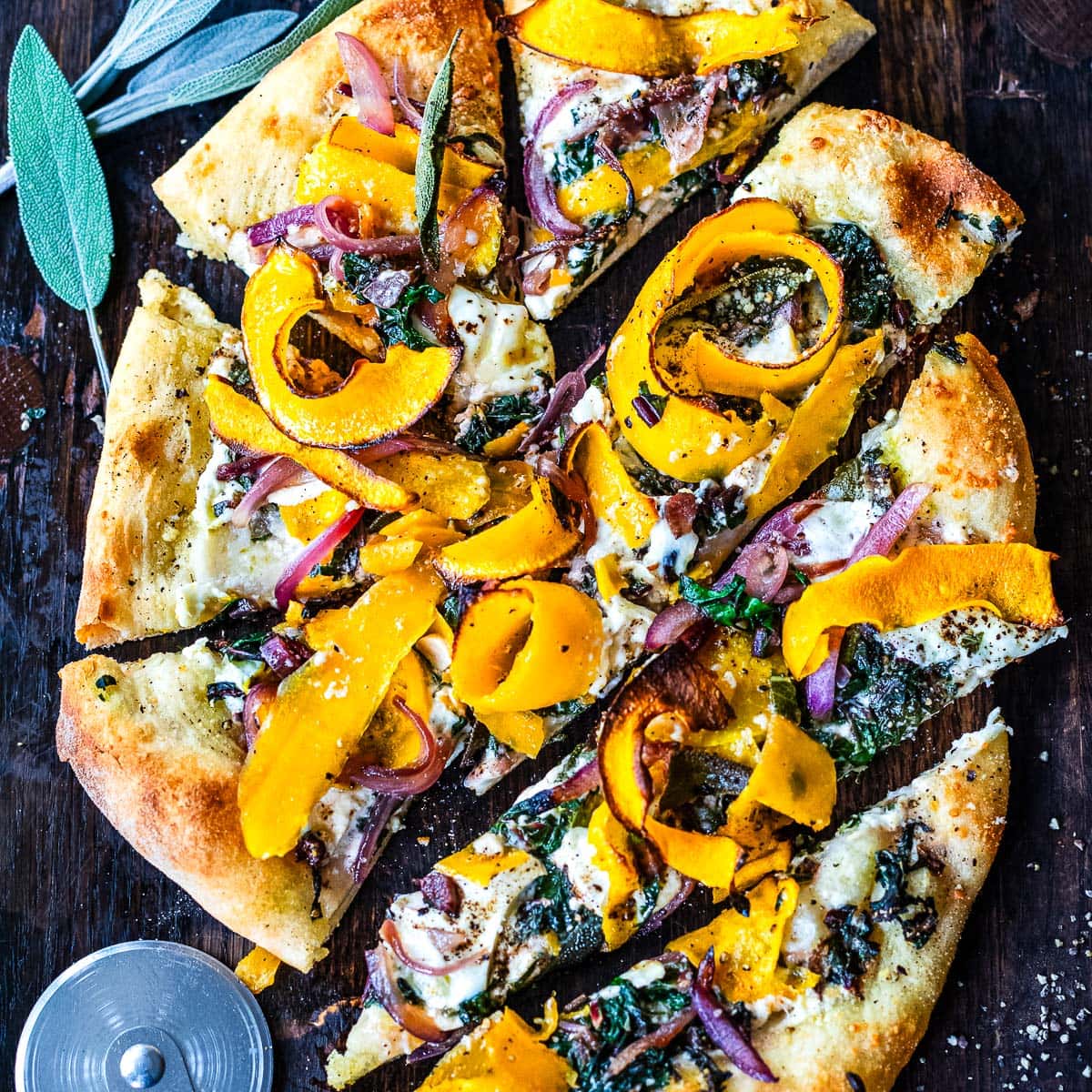 A delicious fall-inspired pizza topped with butternut squash ribbons, sage, caramelized onions, swiss chard and burrata cheese. Cozy fall flavors make the perfect bite!