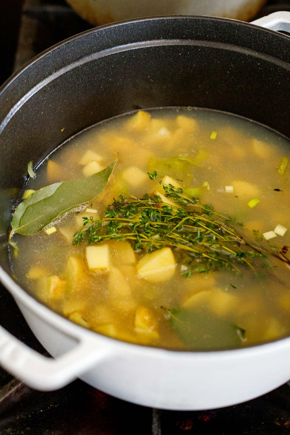 soup pot with potatoes, leeks, thyme, bay leaves