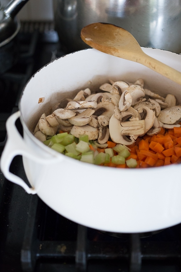 ingredients cooking in a dutch oven. 