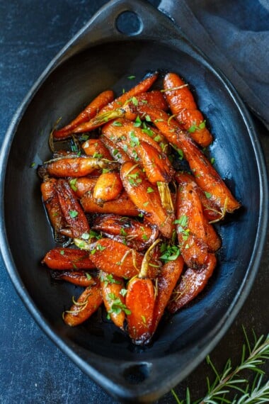 This simple Glazed Carrots recipe is a delightful addition to any meal, tender and succulent with just the right balance of sweet and tangy. Special enough for the holiday table and easy enough for weeknight dinners. Vegan-adaptable.