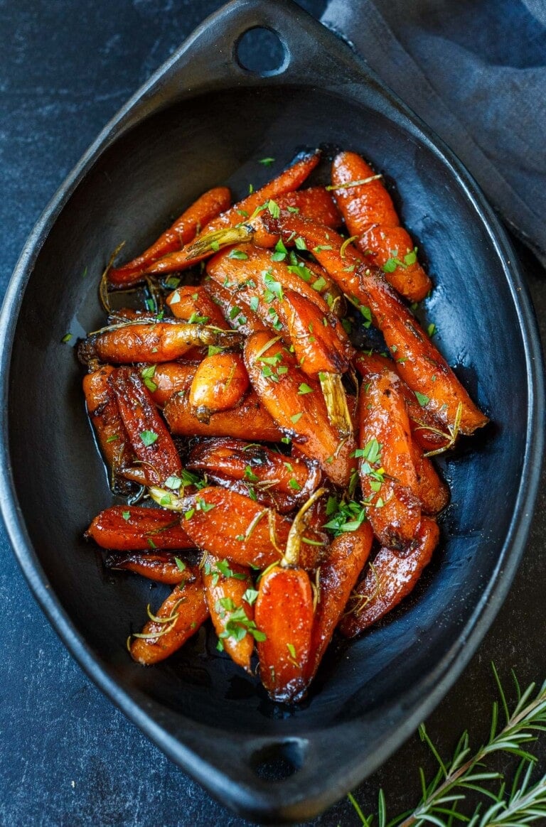 This simple Glazed Carrots recipe is a delightful addition to any meal, tender and succulent with just the right balance of sweet and tangy. Special enough for the holiday table and easy enough for weeknight dinners. Vegan-adaptable.