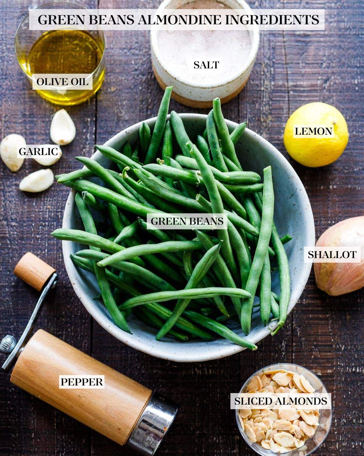 ingredients laid out for green beans almondine - green beans, lemon, shallot, salt, pepper, garlic, oil, sliced almonds