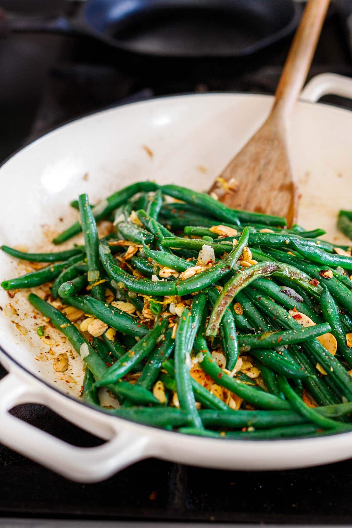 green beans almondine in saute pan with sliced almonds
