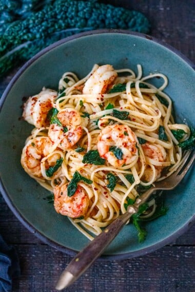 This Shrimp Pasta recipe is fast, easy and full of punchy flavor! Olive oil, lemon zest, fresh garlic, kale and red pepper flakes keep it light and flavorful. A delicious pasta dinner, ready in under 30 minutes.
