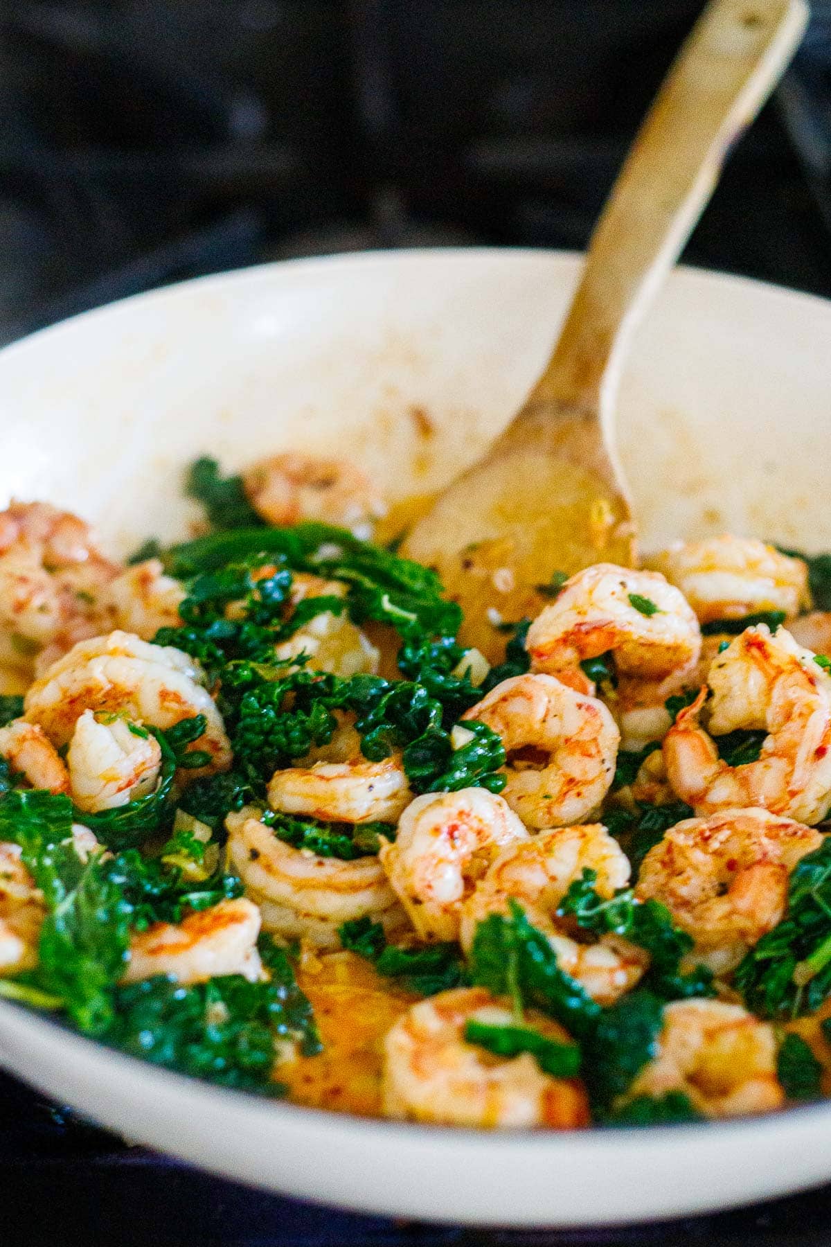 shrimp and kale cooking in pan