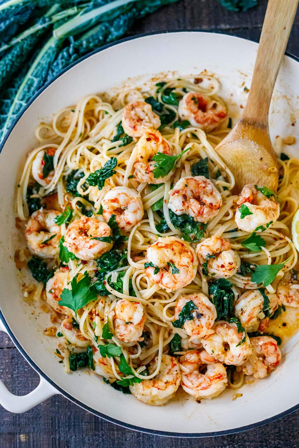 pan of shrimp pasta with wilted kale, fresh herbs