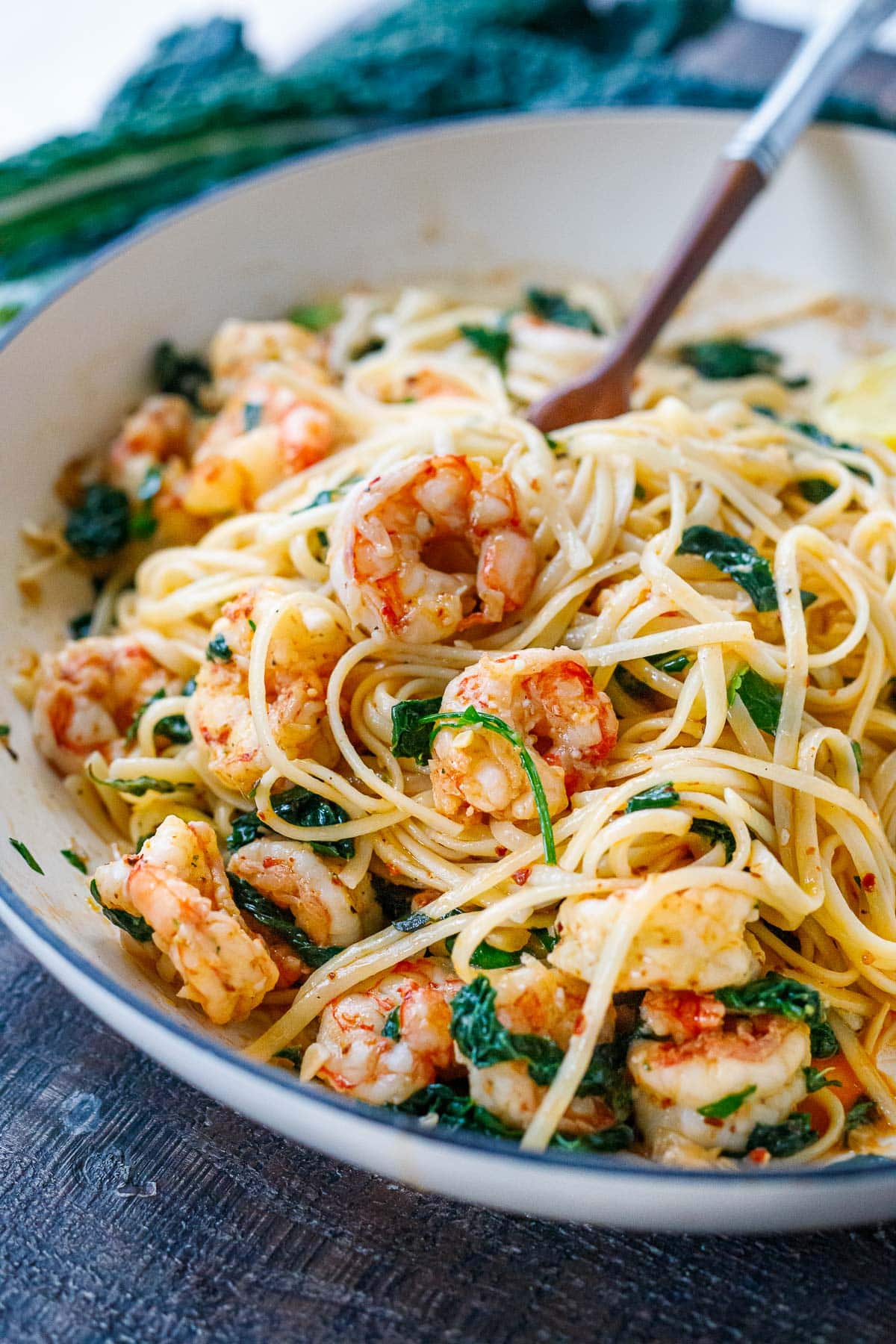 bowl of shrimp pasta with linguine, shrimp, and wilted greens