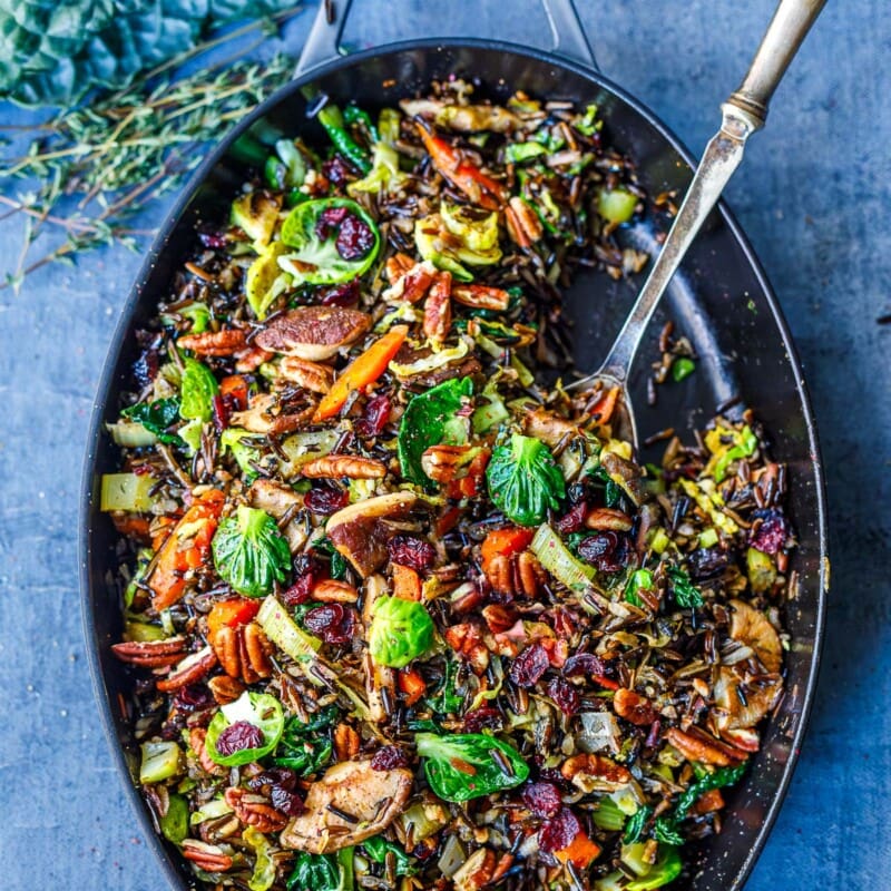 This Wild Rice Pilaf recipe is hearty, textural and savory. Nutty wild rice is paired with mushrooms, pecans, leeks, Brussels sprouts, and craisins. A lovely colorful side dish that is vegan and gluten-free.