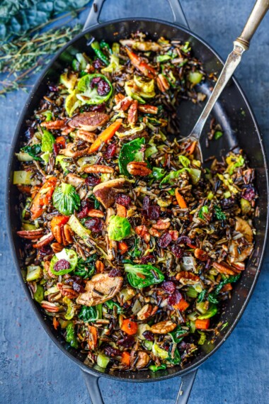 This Wild Rice Pilaf recipe is hearty, textural and savory. Nutty wild rice is paired with mushrooms, pecans, leeks, Brussels sprouts, and craisins. A lovely colorful side dish that is vegan and gluten-free.