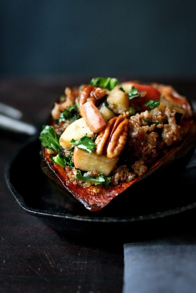 Roasted Acorn Squash with sausage, apple, parsnips, pecans and sage. Vegan-adaptable! #acornsquash #stuffedsquash