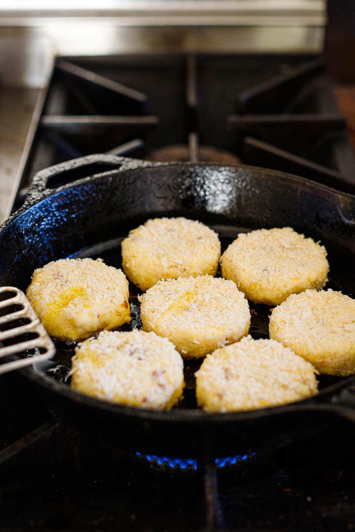 cooking mashed potato cakes on cast iron skillet 