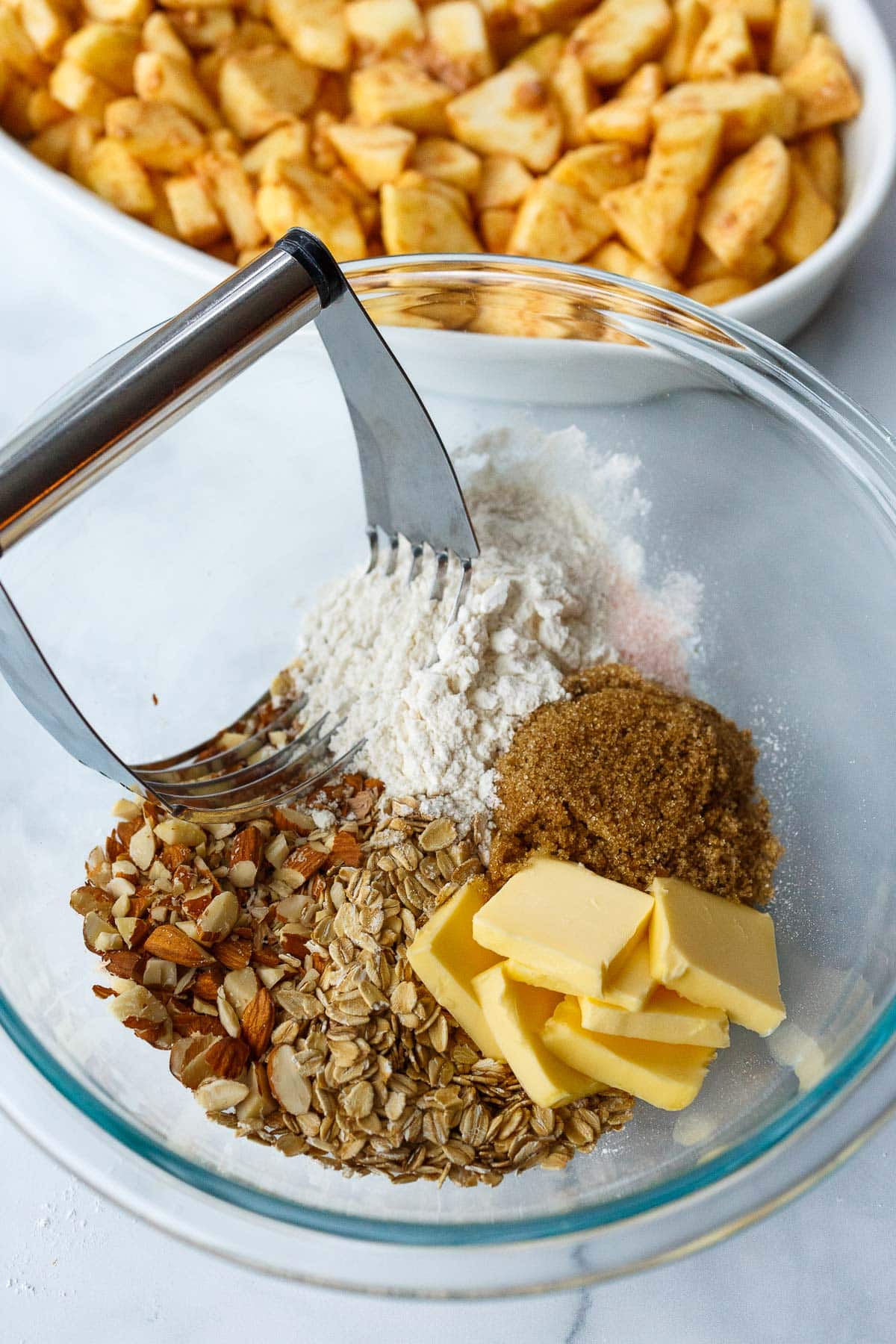 butter, oats, almonds, flour, brown sugar, salt in mixing bowl with pastry cutter