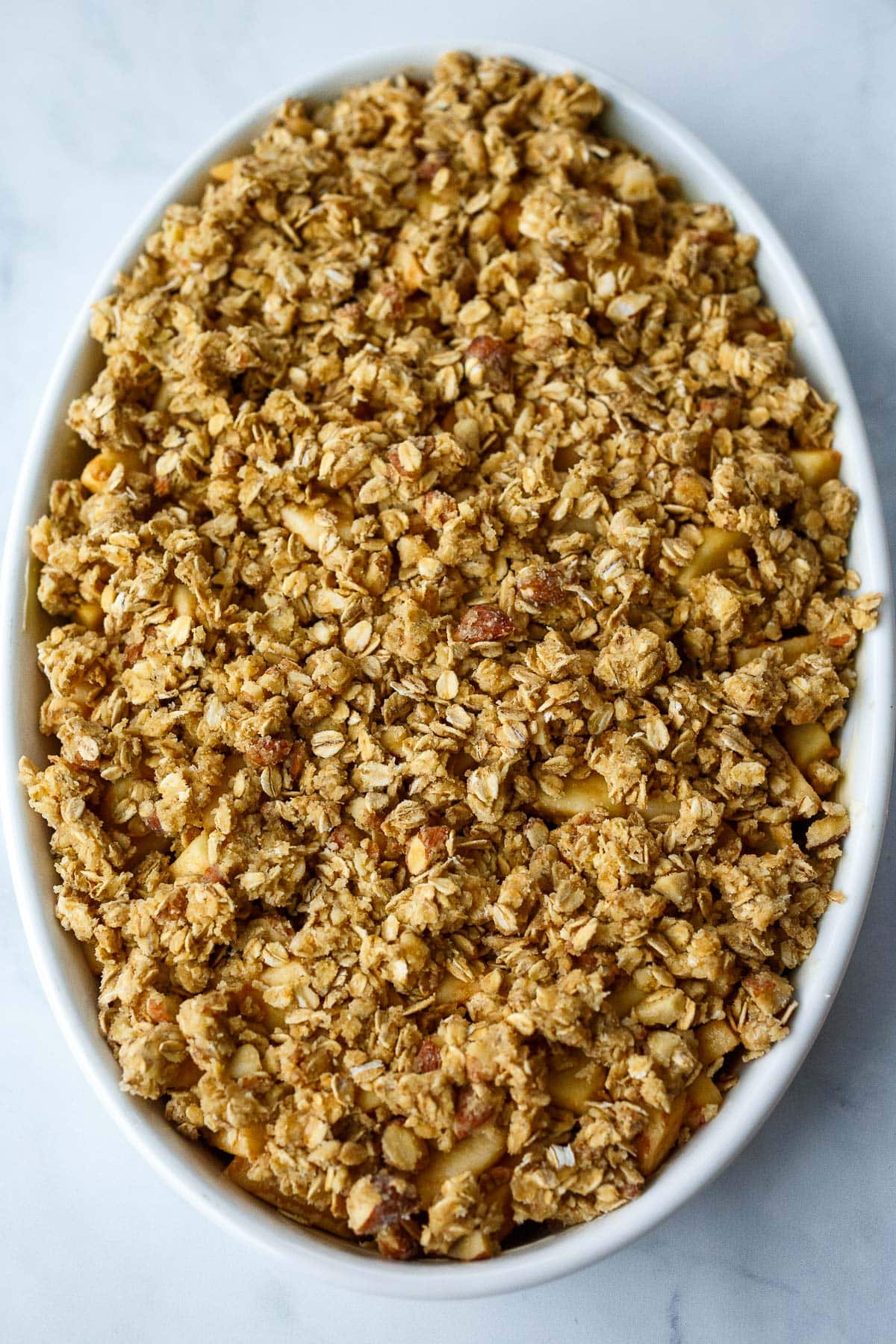 oat crumble topping in casserole dish for baked apple crisp recipe
