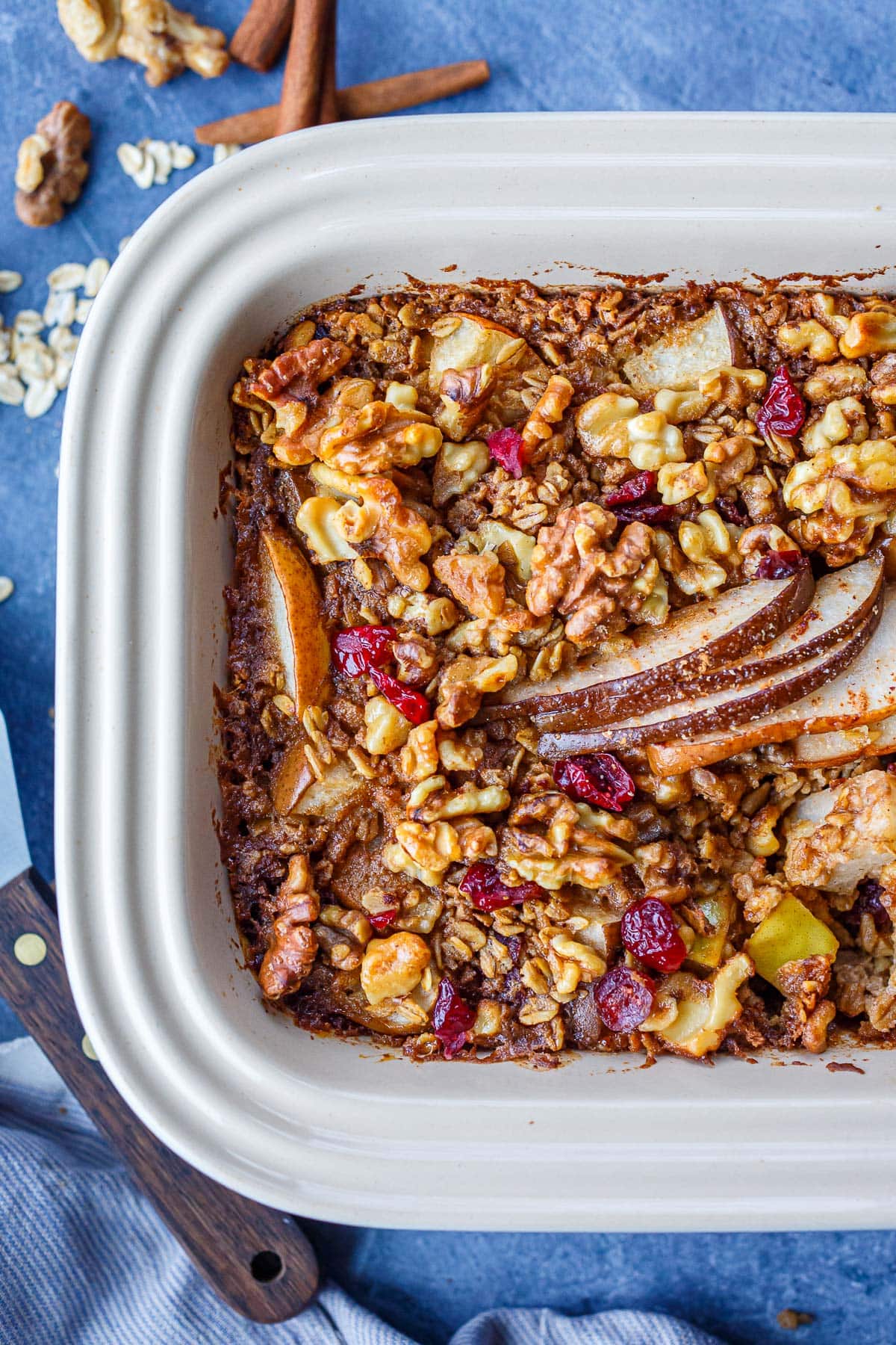 baked oatmeal with slices of pear, dried cranberries, and walnuts
