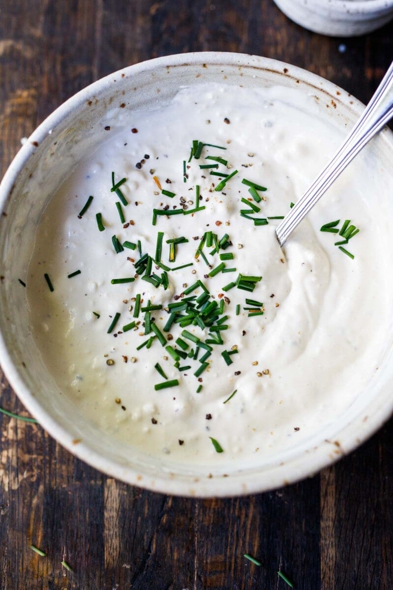 This lightened-up Blue Cheese Dressing recipe is creamy, punchy and flavorful! Made with yogurt instead of mayo, it contains half the calories of most other recipes without lacking in flavor.