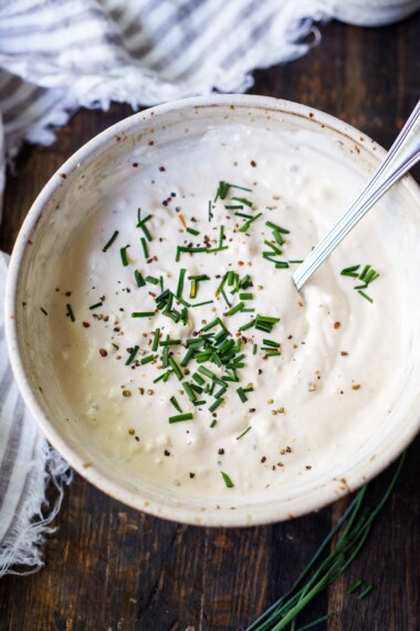 This lightened-up Blue Cheese Dressing recipe is creamy, punchy and flavorful! Made with yogurt instead of mayo, it contains half the calories of most other recipes without lacking in flavor.