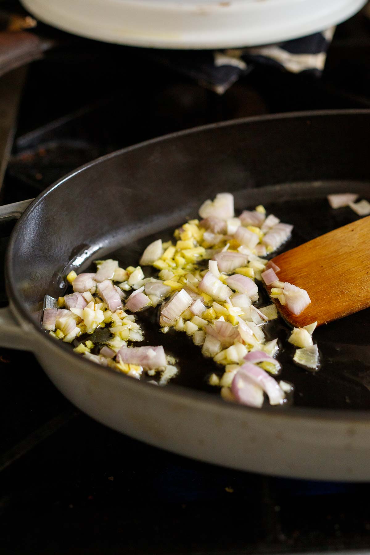 garlic and shallot sauteeing in large skillet with oil 