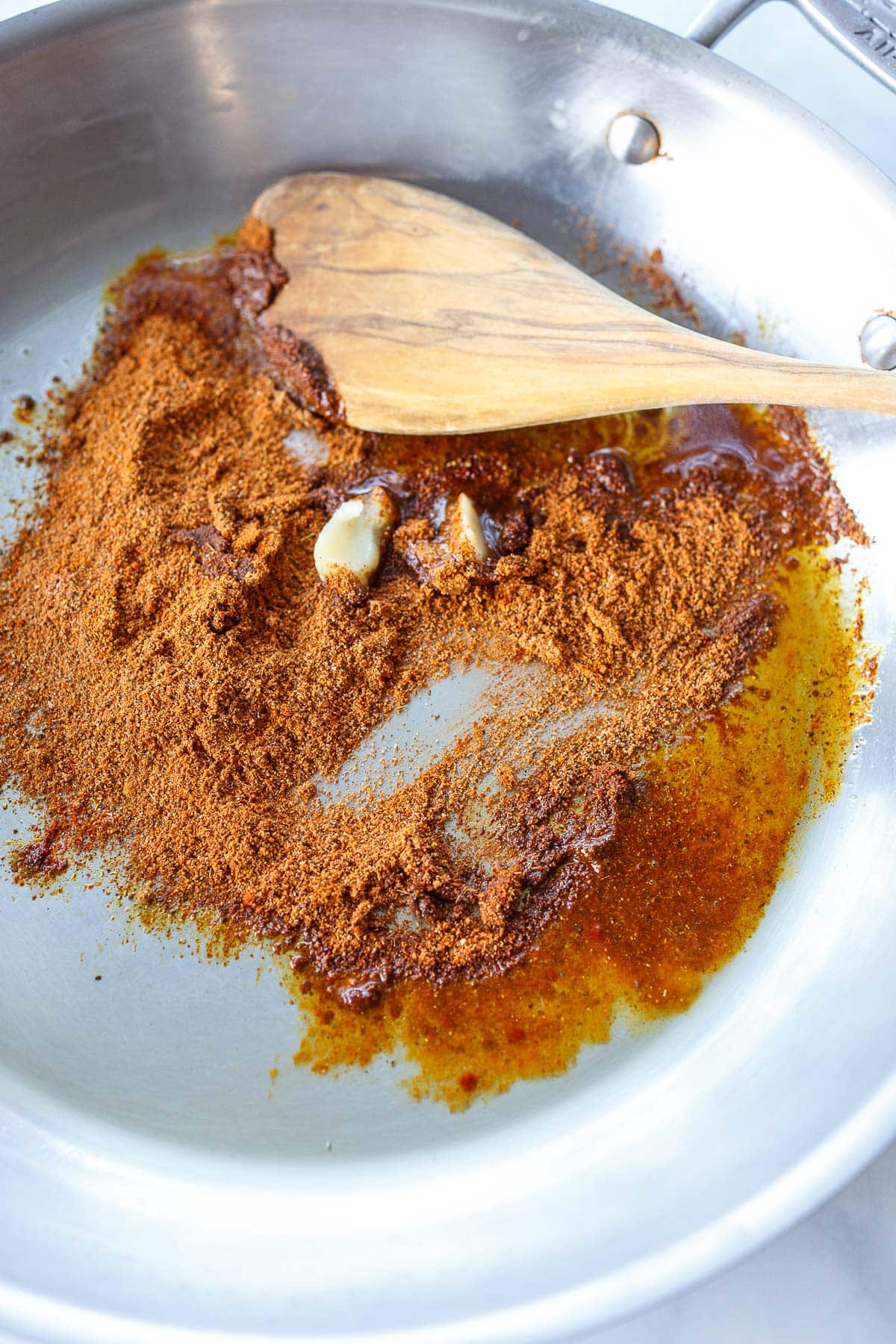 ground Indian spices sautéing in skillet