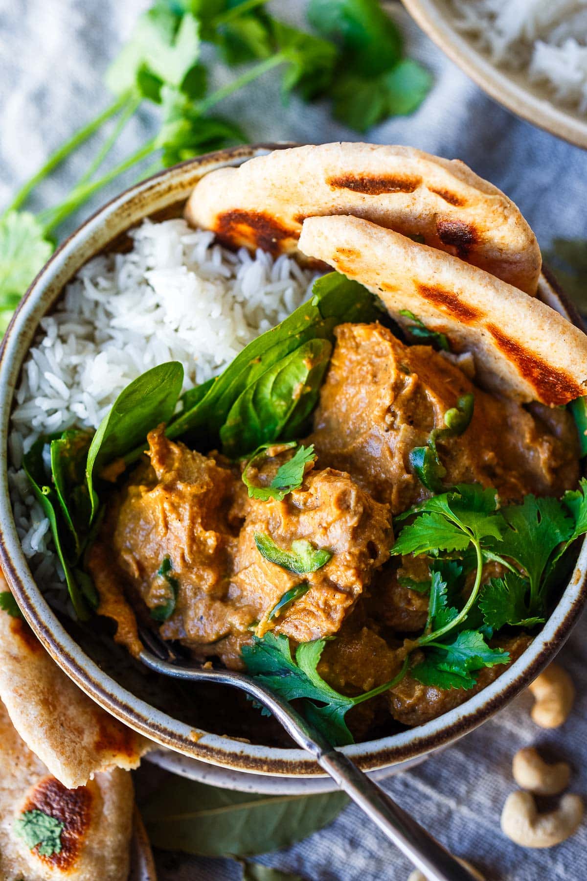 A simplified Indian classic, this Chicken Korma recipe is easy and lively with so much flavor! Tender chicken cooked in a luscious yogurt sauce with fragrant Indian spices. 