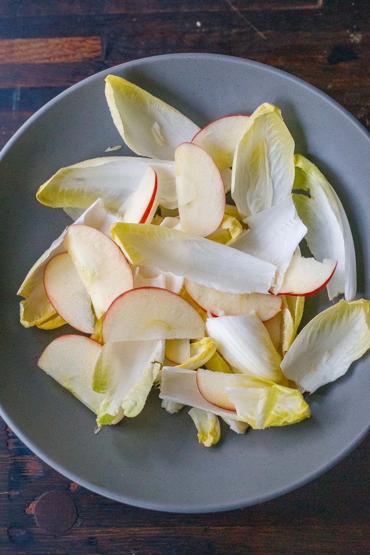 endive leaves and sliced apples in bowl