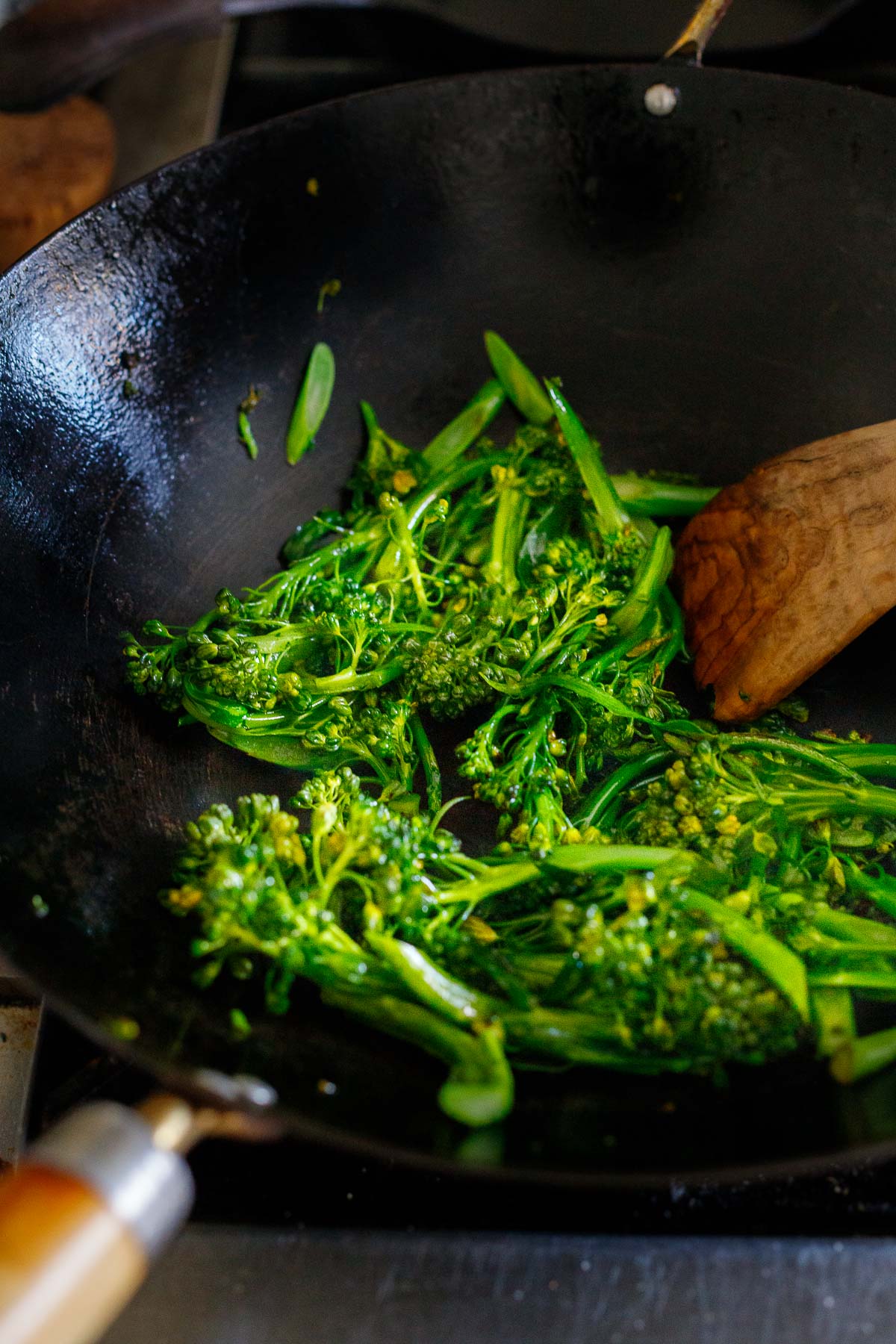 sliced broccolini frying in wok