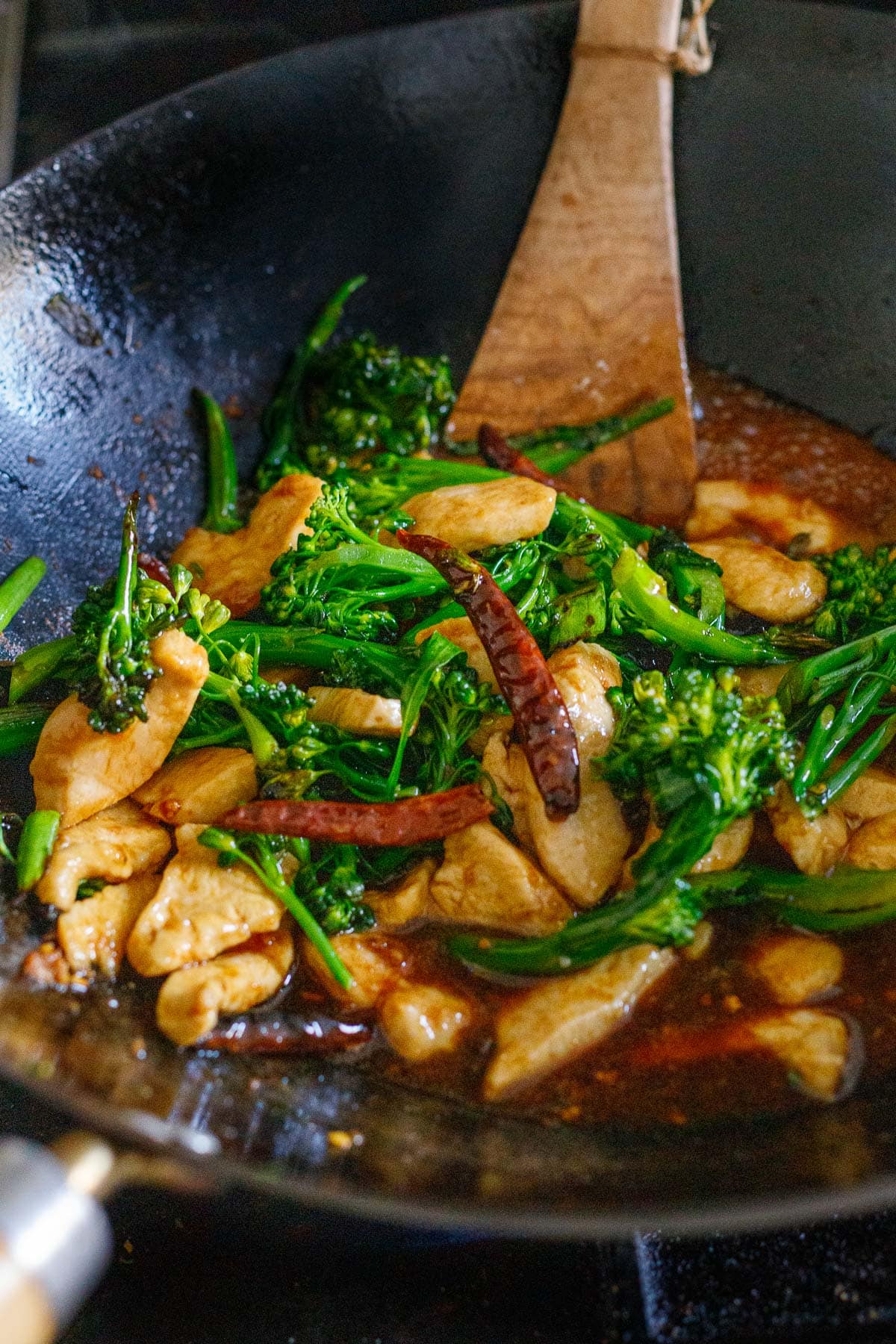 veggies, chicken, and dried chilies in wok stir frying
