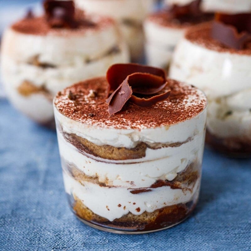 tiramisu in glass jar with cocoa powder and shaved chocolate garnish