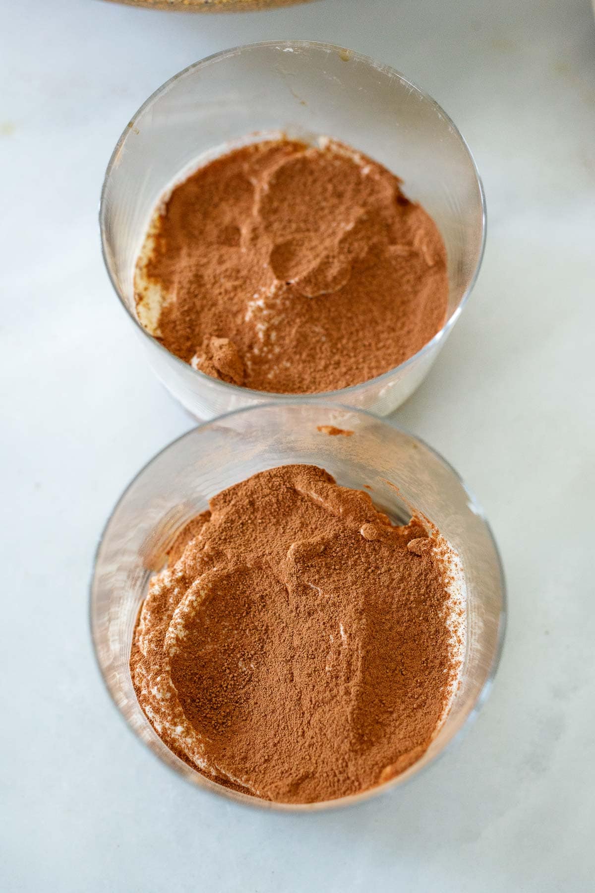 generous dusting of cocoa powder on top of tiramisu layers