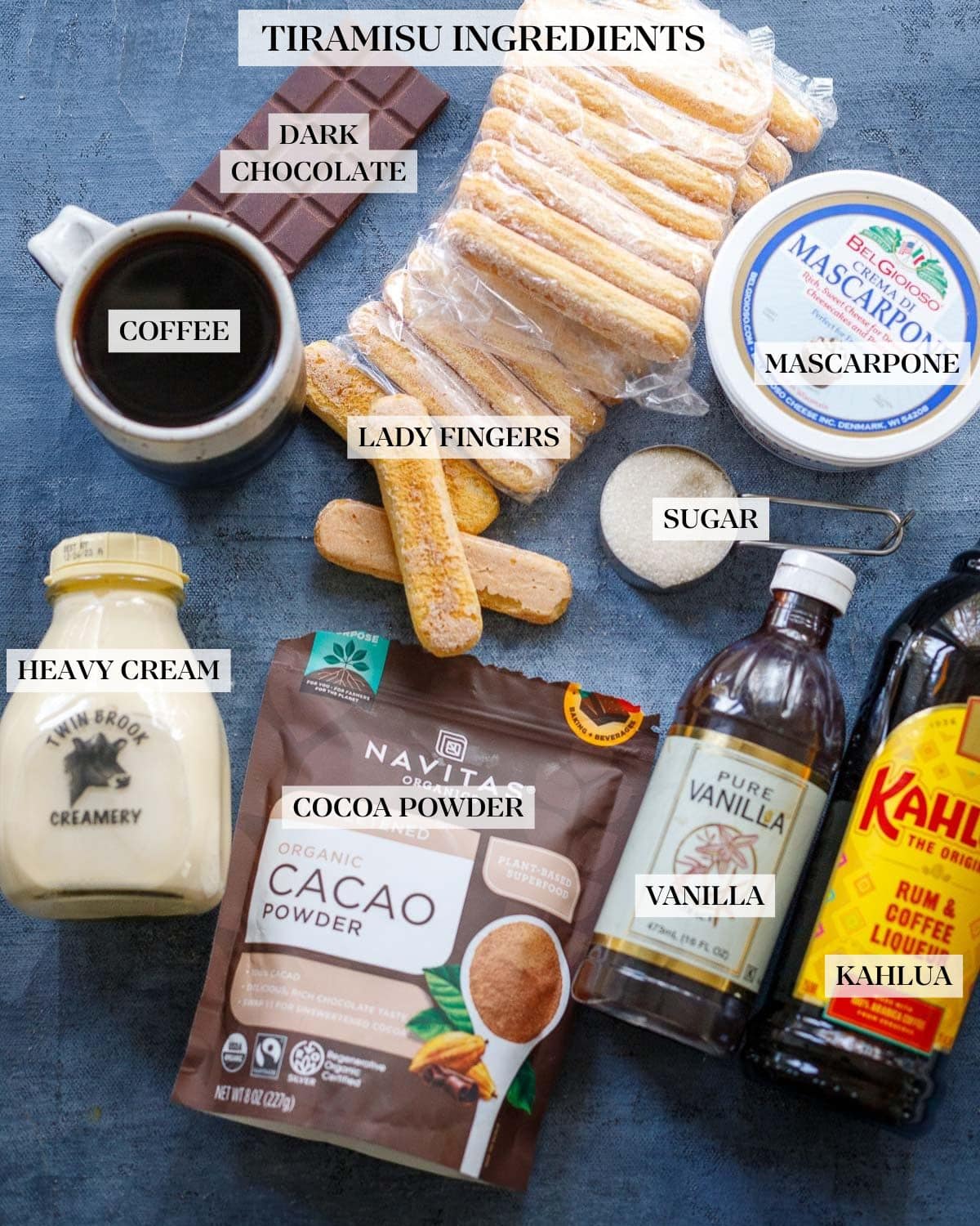 ingredients for tiramisu on table - coffee, ladyfingers, chocolate, mascarpone, sugar, cream, cacao powder, vanilla, Kahlua
