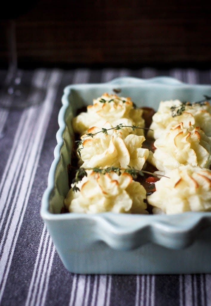 Vegan Shepherds Pie with mushrooms and root vegetables- topped with pillowy mashed potatoes. A delicious vegan main dish -perfect for the holiday table. #sheperdspie #vegan