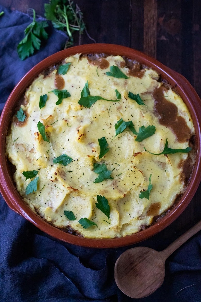 Vegan Shepherds Pie with mushrooms and root vegetables- topped with pillowy mashed potatoes. A delicious vegan main dish -perfect for the holiday table. #sheperdspie #vegan