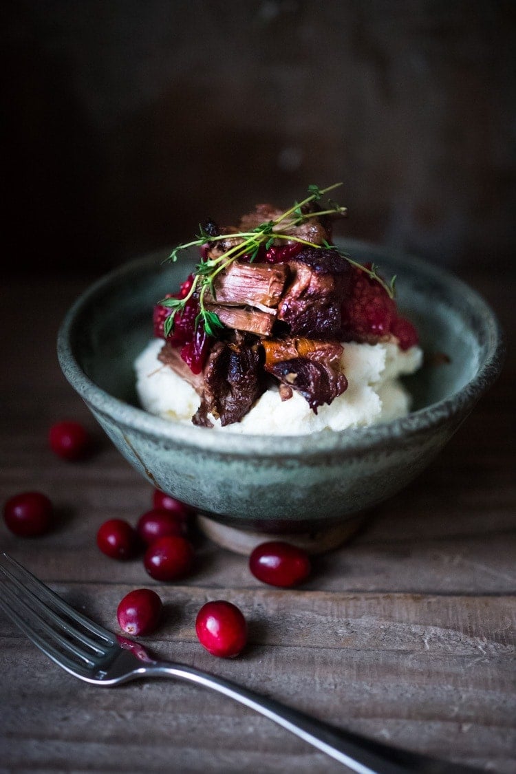 This Cranberry Pot Roast recipe is so simple and festive! Made with beef or lamb roast, fresh cranberries and roasted in the oven until tender, juicy and flavorful! Perfect for the holidays or a simple Sunday supper.
