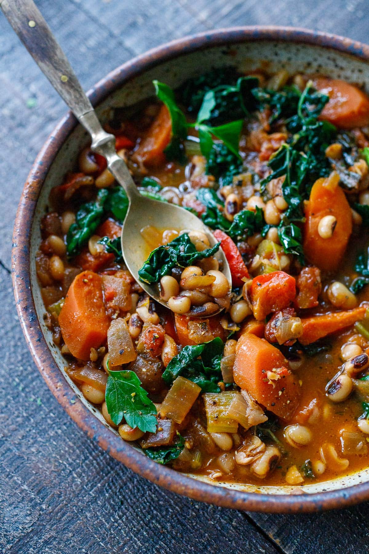 black eyed pea soup with kale and vegetables in bowl with soup.