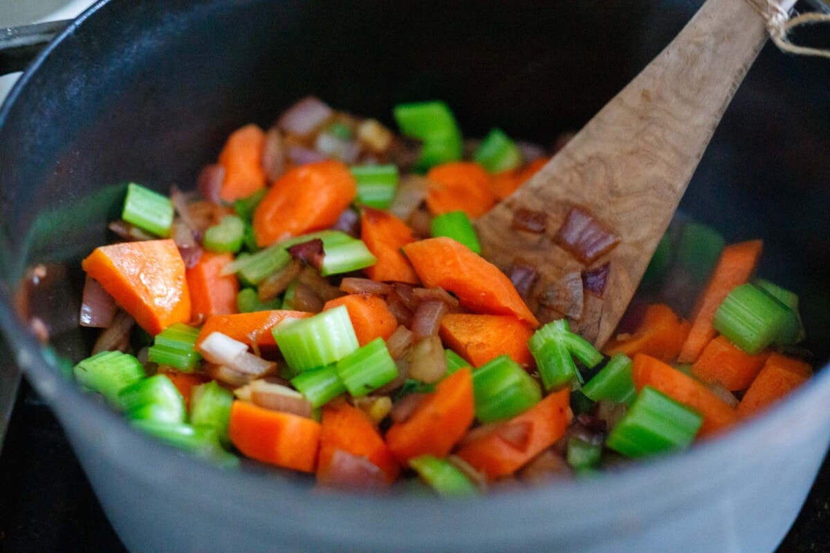 diced carrots, celery, onion in pot stirred with wood spoon.